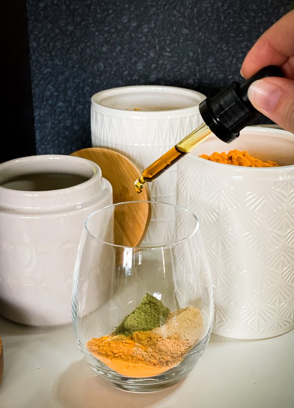 Golden Milk recipe ingredients with CBD-oil being added to a powder mixture